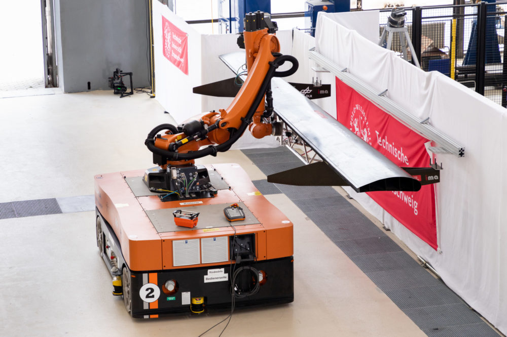 Mobiler Roboter mit Montagevorrichtung und eingespannter Landeklappe in Montageposition (Bildnachweis: Markus Hörster, TU Braunschweig)